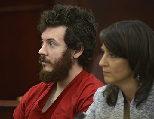 FILE - In this March 12, 2013 file photo, James Holmes, left, and defense attorney Tamara Brady appear in district court in Centennial, Colo. for his arraignment. Prosecutors say they are not are ready to accept an offer from Colorado theater shooting suspect James Holmes to plead guilty in exchange for avoiding the death penalty. In a court filing Thursday, March 28, 2013 prosecutors criticized defense attorneys for publicizing Holmes' offer to plead guilty. (AP Photo/The Denver Post, RJ Sangosti, Pool, File)