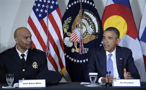 President Barack Obama, sitting next to Denver Police Chief Robert White, participates in a meeting at the Denver Police Academy in Denver, Colo., with local law enforcement officials and community leaders to discuss the state's new measures to reduce gun violence, Wednesday, April 3, 2013. (AP Photo/Susan Walsh)